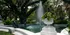 Serene garden scene with a picturesque fountain surrounded by lush greenery and elegant statues, perfect for tranquil relaxation.