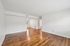 Spacious living area with beautiful hardwood floors and abundant natural light.