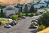 Charming hillside apartment complex with green spaces, ample parking, and scenic views.