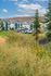 Charming apartment complex nestled in serene green landscape with scenic countryside views and ample parking.