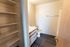 Modern bathroom with elegant shelving, sleek vanity, and premium flooring.