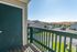 Inviting entryway balcony showcasing scenic views of a peaceful neighborhood with rolling hills in the distance.