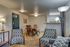 Inviting open-plan living and dining area featuring stylish patterned chairs, elegant wooden dining set, and warm lighting, ideal for entertaining.