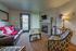 Cozy living room with modern furniture, vibrant decor, and a warm fireplace, perfect for relaxation and entertainment.