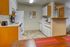 Inviting kitchen with modern appliances, warm wood cabinetry, and sleek countertops, perfect for culinary adventures.