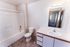 Inviting bathroom with a clean bathtub, elegant sink, and modern lighting, perfect for relaxation and functionality.