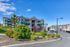 Charming apartment complex featuring modern design with lush landscaping and vibrant exterior colors.