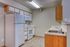Charming kitchen with modern white appliances, sleek countertops, and warm wooden cabinets, perfect for a contemporary lifestyle.