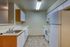 Modern kitchen with sleek wooden cabinets, stainless steel sink, and spacious countertops, ideal for culinary enthusiasts.