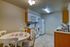 Charming kitchen with cozy dining area, bright lighting, and modern appliances for a welcoming atmosphere.