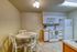 Cozy kitchen with modern appliances, warm cabinetry, and an inviting dining area perfect for intimate gatherings.