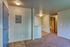 Inviting entryway featuring a blend of tiled and carpeted floors, leading to a cozy hallway with a view into the bathroom, perfect for modern living.