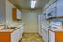 Inviting kitchen with modern appliances, sleek white cabinetry, and elegant countertops, creating the perfect space for culinary creativity.