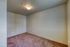 Cozy room with plush carpet flooring and soft lighting, perfect for versatile living space.
