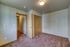 Cozy bedroom with plush carpet, wood-paneled doors, and soft ambient lighting, offering a warm and inviting atmosphere.