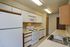 Bright, inviting kitchen with sleek white cabinetry, modern appliances, and ample counter space for effortless cooking.