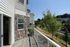Charming apartment balcony with scenic views of lush greenery, perfect for relaxation on sunny days.