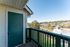 Charming balcony view with vibrant green surroundings and panoramic townscape, perfect for relaxation.