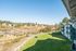 Stunning view of lush green lawns and a scenic countryside, perfect for tranquil apartment living with easy access to nature.