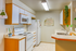 Bright and cozy kitchen with modern white appliances, stylish cabinetry, and welcoming natural accents.