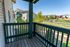 Charming balcony view with vibrant greenery, providing a peaceful outdoor space in a modern apartment complex.