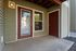 Charming entryway with inviting glass door and warm exterior lighting, providing a welcoming entrance to a cozy apartment.