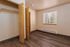 Bright bedroom with sleek wood flooring, large closet space, and a sunlit window providing ample natural light.