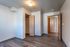 Inviting room with sleek wood flooring and a spacious closet, perfect for modern living.