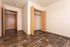 Inviting bedroom with elegant wood flooring and spacious built-in closet, perfect for modern living.