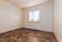 Bright, cozy room with warm wooden floors and natural light streaming through large window, perfect for a serene atmosphere.