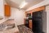 Modern kitchen with sleek black appliances, warm wooden cabinets, and elegant countertops.