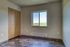 Bright room with elegant wood flooring, picturesque window view, and ample closet storage, perfect for serene living.
