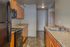 Modern kitchen with sleek black appliances, ample wooden cabinetry, and elegant granite countertops.