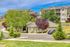 Charming apartment complex surrounded by lush greenery and vibrant trees, offering a serene residential environment with modern architecture.