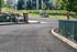 Charming entrance to Birch Hills Apartments surrounded by lush greenery and welcoming urban environment.