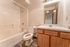 Bright, modern bathroom featuring a sleek bathtub, elegant vanity with ample storage, and contemporary fixtures.