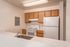 Inviting kitchen with modern appliances, sleek countertops, and warm wooden cabinetry. Perfect for culinary creativity.