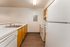 Bright, modern kitchen with sleek countertops, warm wood cabinetry, and high-end appliances.