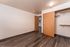 Bright and welcoming bedroom with sleek hardwood flooring and ample closet space, perfect for modern living.