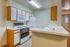 Bright and inviting modern kitchen with white cabinetry, sleek surfaces, and efficient appliances designed for a stylish lifestyle.