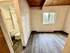 Charming room featuring elegant wooden ceiling, large window with scenic views, and an inviting en-suite bathroom.