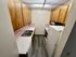 Charming kitchen with warm wooden cabinets, sleek countertops, and retro pink tile backsplash, perfect for cozy culinary adventures.