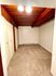 Cozy room with soft carpet flooring and elegant wood-paneled ceiling, featuring built-in closets for ample storage.