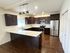 Modern kitchen design featuring dark wood cabinets, stainless steel appliances, and elegant countertops with a chic backsplash.