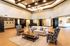Elegant and spacious lobby with high ceilings, cozy seating area, and modern chandelier, perfect for social gatherings.