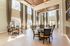 Elegant public lounge with high ceilings, large windows, and chic seating arrangement in a luxurious apartment building.