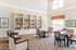 Inviting community library with elegant seating and bright windows, perfect for relaxation and reading.