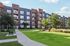 Modern apartment complex with sleek design, lush green landscaping, and a bright, inviting atmosphere.