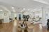 Chic salon interior featuring modern styling chairs, luxurious pedicure stations, and sleek wood flooring.