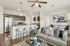 Modern open-concept living area with sleek kitchen, cozy sofa, and stylish dining space, ideal for entertaining.